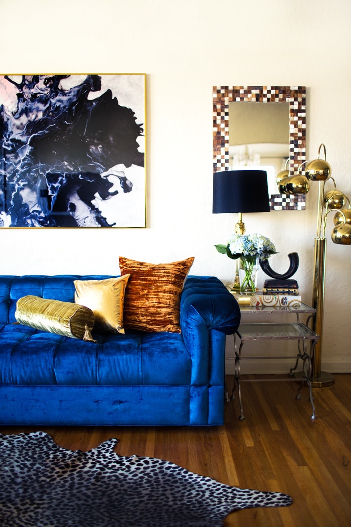 Bold Blue Velvet Sofa Paired with Gold and Animal-print Accents