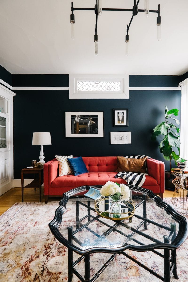 Living room with dark wall and red sofa