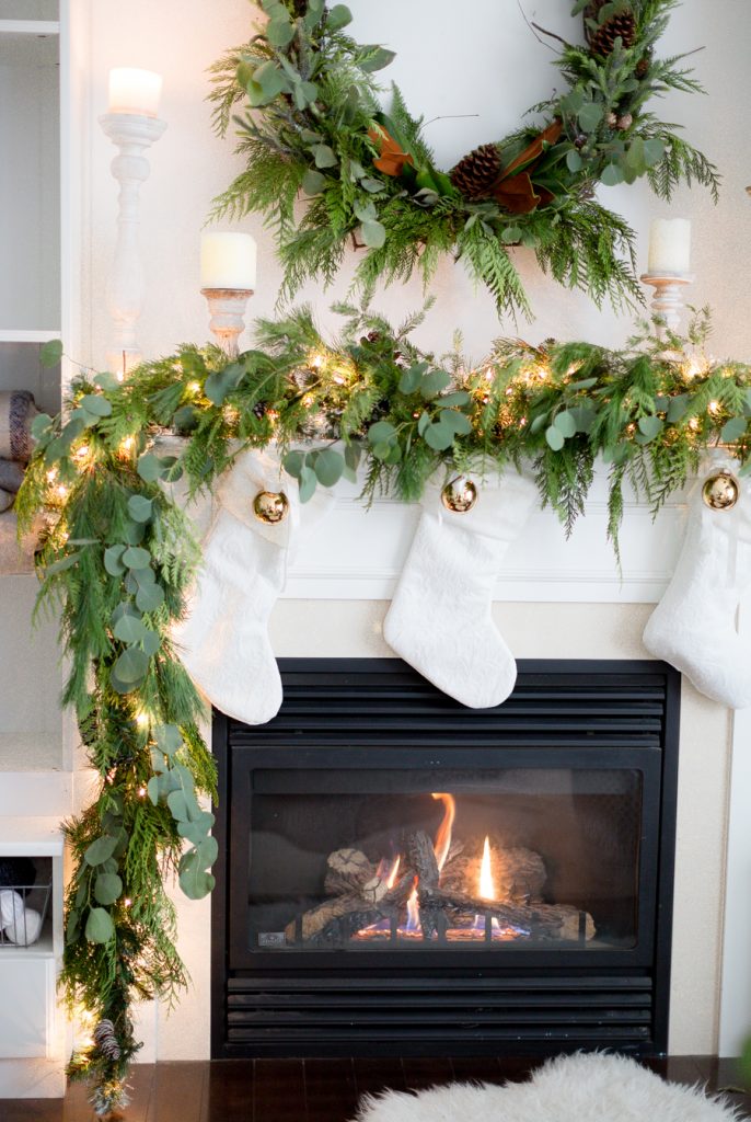 Real Garland and White Stockings Christmas Mantel​