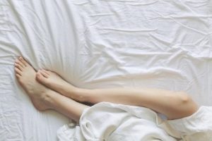 A woman sleeping on a mattress.s.