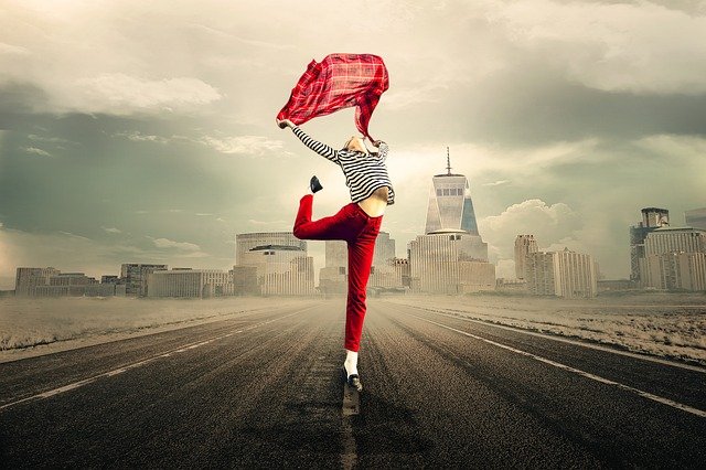 A woman flying her stole in the air.