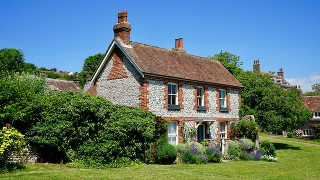 A two storey house surrounded by trees.