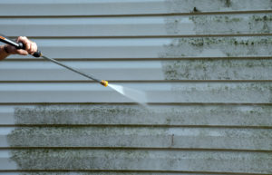 Man spraying paint on the walls.