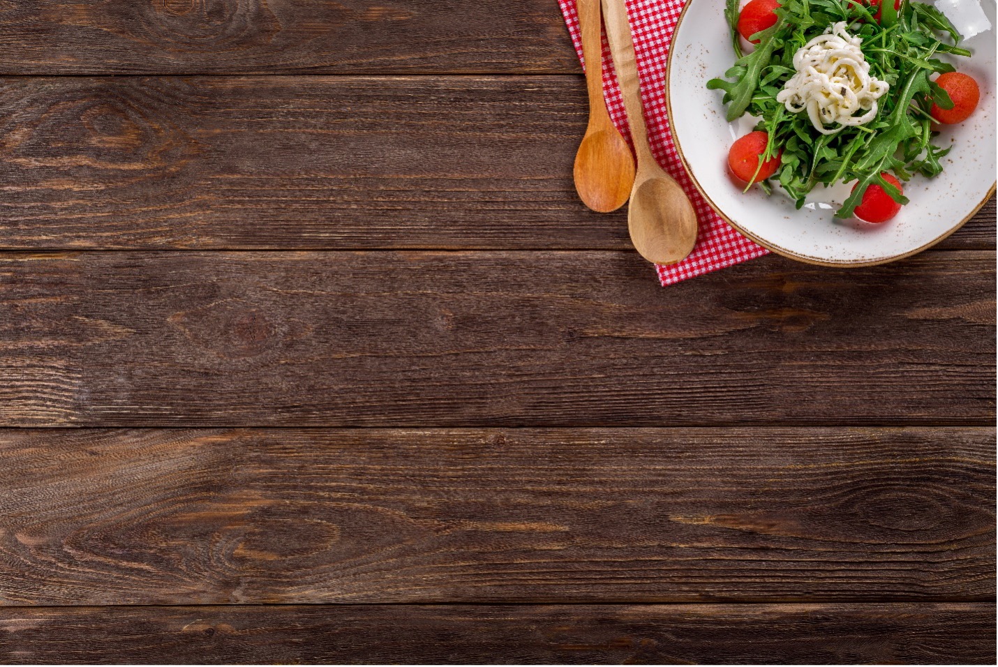 A wooden table top with a food plate on it.