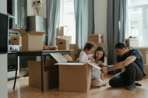 Family packing up stuff in boxes.