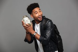 A man holding a money jar.