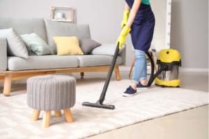 Woman cleaning the carpet