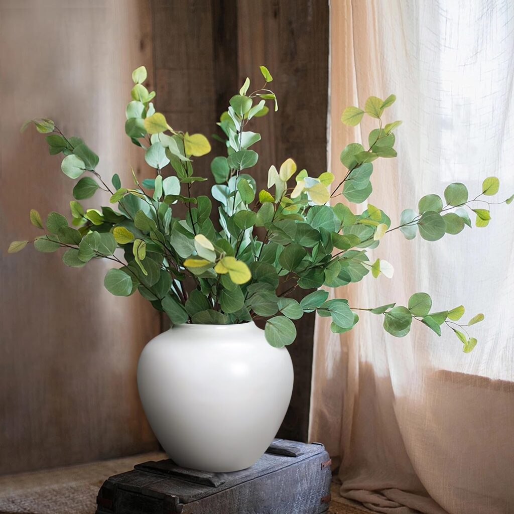 A Simple Ceramic Vase With Fresh Greens